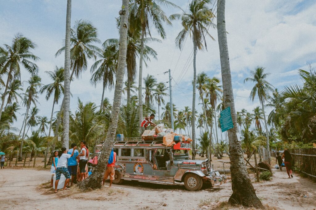 Trees and people sitting on a van Philippines